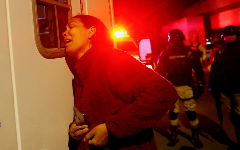 Viangly, a Venezuelan migrant, outside an ambulance for her injured husband Eduard Caraballo - Reuters