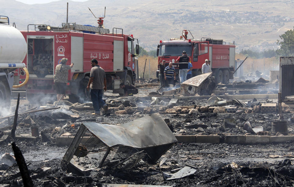 <p>Lebanese firefighters inspect the damage caused by a massive fire in a camp for Syrian refugees near the village of Qab Elias in the Lebanese Bekaa valley on July 2, 2017.<br> A massive fire in a camp for Syrian refugees in central Lebanon killed one person and wounded six others, the Red Cross said, adding that hundreds were evacuated. (Hassan Jarrah/AFP/Getty Images) </p>