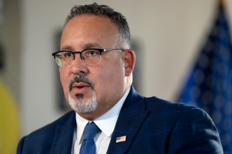 FILE - Education Secretary Miguel Cardona speaks during an interview with The Associated Press in his office at the Department of Education, Sept. 20, 2023, in Washington. The Biden administration is asking America's colleges to renew their efforts to make campuses more racially diverse, urging schools to boost scholarships and minority recruiting and to give “meaningful consideration” to the adversity students face because of their race or finances. (AP Photo/Mark Schiefelbein, File)