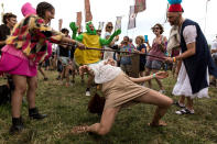 <p>Festival goers limbo at the Glastonbury music festival at Worthy Farm, in Somerset, England, Thursday, June 22, 2017. (Photo: Grant Pollard/Invision/AP) </p>