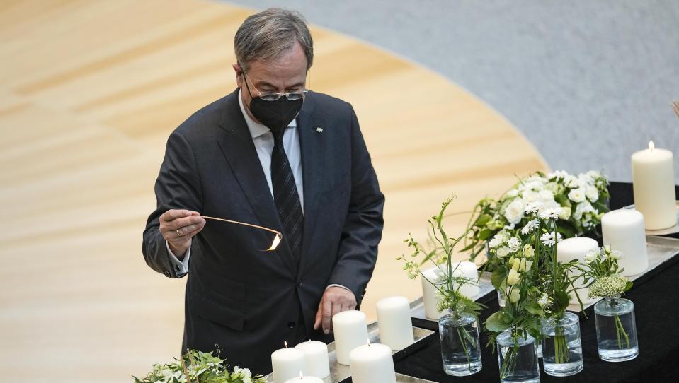 Governor of North Rhine-Westphalia and CDU top candidate for chancellor at the German general elections Armin Laschet lights candles during a commemoration for the victims of the coronavirus pandemic at the state parliament in Duesseldorf, Germany, Wednesday, June 30, 2021. (AP Photo/Martin Meissner)