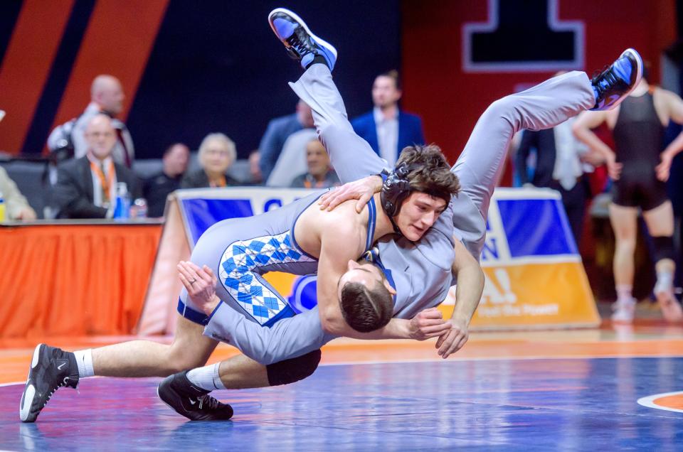 Olympia's Bentley Wise tosses coach Josh Collins after defeating Herrin's Blue Bishop in the 150-pound match of the Class 1A state wrestling championships Saturday, Feb. 17, 2024 at the State Farm Center in Champaign.