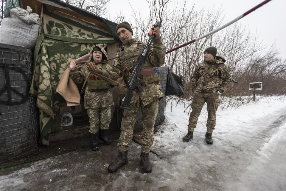 Ukrainian servicemen guard a checkpoint at the line of separation in the Luhansk region, in Luhansk, Ukraine, Thursday, Feb. 3, 2022. When the U.S. and NATO rejected the Kremlin's security demands over Ukraine last week, fears of an imminent Russian attack against its neighbor soared. (AP Photo/Andriy Dubchak)