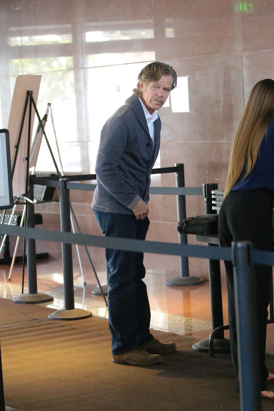 William H. Macy arrived at a federal building in Los Angeles where Huffman was being held for questioning. Source: Splash News