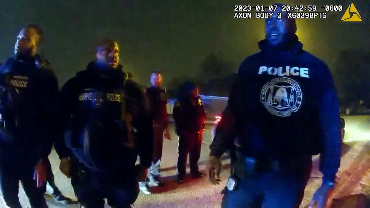 Memphis Police Department officers stand near Tyre Nichols, a 29-year-old Black man who was pulled over while driving, beaten and died three days later, on January 7, 2023. (Memphis Police Department/Handout via REUTERS)