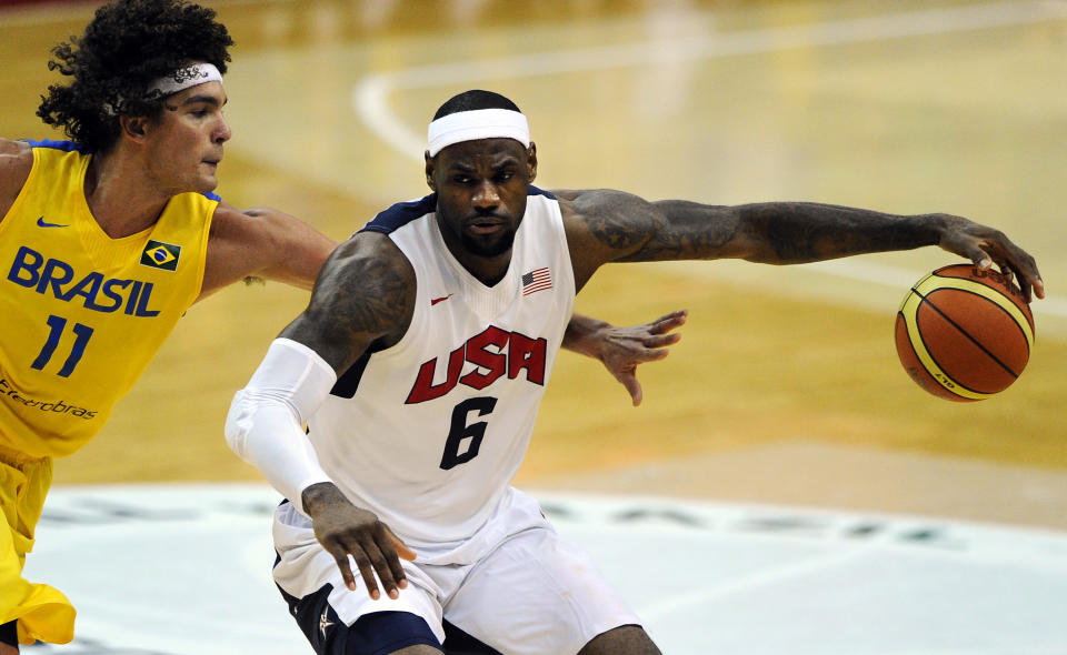 WASHINGTON, DC - JULY 16: LeBron James #6 of the US Men's Senior National Team dribbles past Anderson Franca Varejao #11 of Brazil in the third quarter during a pre-Olympic exhibition basketball game at the Verizon Center on July 16, 2012 in Washington, DC. The US Senior Men's National Team won, 80-69. (Photo by Patrick Smith/Getty Images)