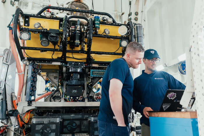 Technicians consult before installing a camera on ROV SuBastian. Photo: Misha Vallejo Prut/Schmidt Ocean Institute