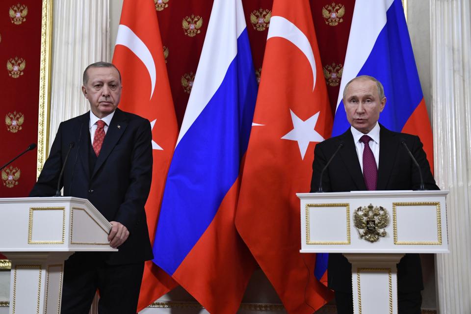 Russian President Vladimir Putin, right, speaks as Turkey's President Recep Tayyip Erdogan listens during their joint news conference following the talks in the Kremlin in Moscow, Russia, Wednesday, Jan. 23, 2019. Russia and Turkey are jockeying for clout in Syria as the U.S. plans to withdraw its troops from the country. (Alexander Nemenov/Pool Photo via AP)