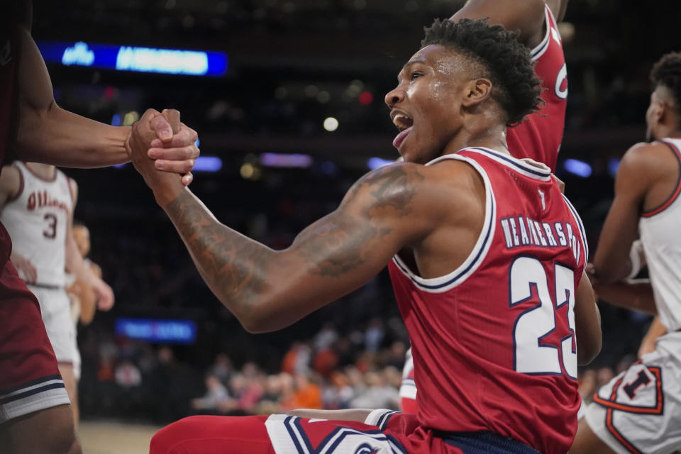 Florida Atlantic guard Brandon Weatherspoon (23) reacts after drawing an offensive foul against Illinois during the first half of an NCAA college basketball game in New York, Tuesday, Dec. 5, 2023. (AP Photo/Peter K. Afriyie)