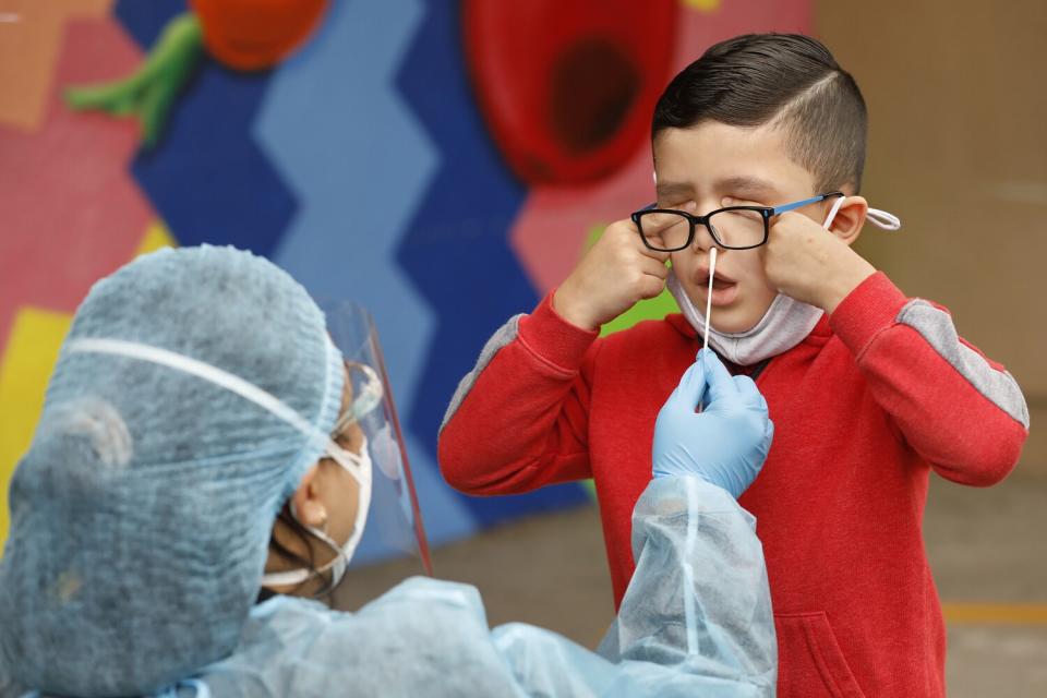 April 13: Kindergartner Matteo Rodriguez gets a nasal COVID-19 test from a healthcare worker.