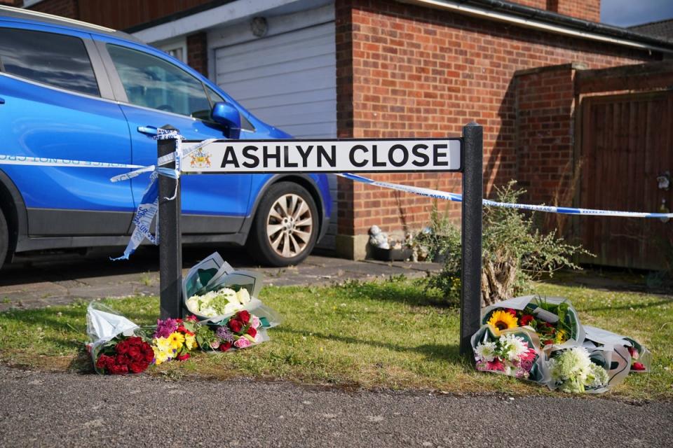 A view of the scene in Ashlyn Close where friends and neighbours laid floral tributes to the family (Jonathan Brady/PA)