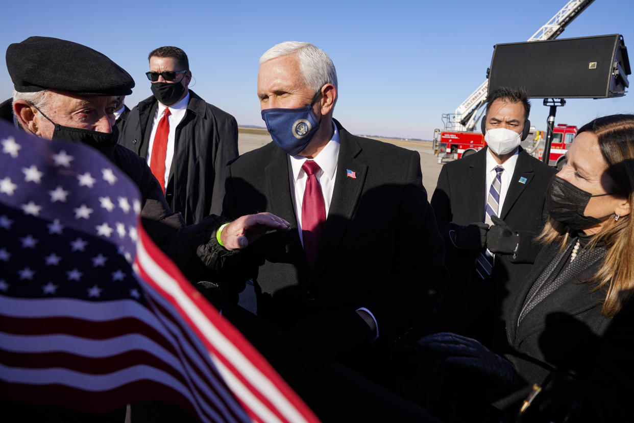FILE - In this Jan. 20, 2021, file photo, former Vice President Mike Pence greets supporters after arriving back in his hometown of Columbus, Ind.  Pence is steadily re-entering public life as he eyes a potential run for the White House in 2024. He's writing op-eds, delivering speeches, preparing trips to early voting states and launching an advocacy group likely to focus on promoting the accomplishments of the Trump administration.(AP Photo/Michael Conroy, File)