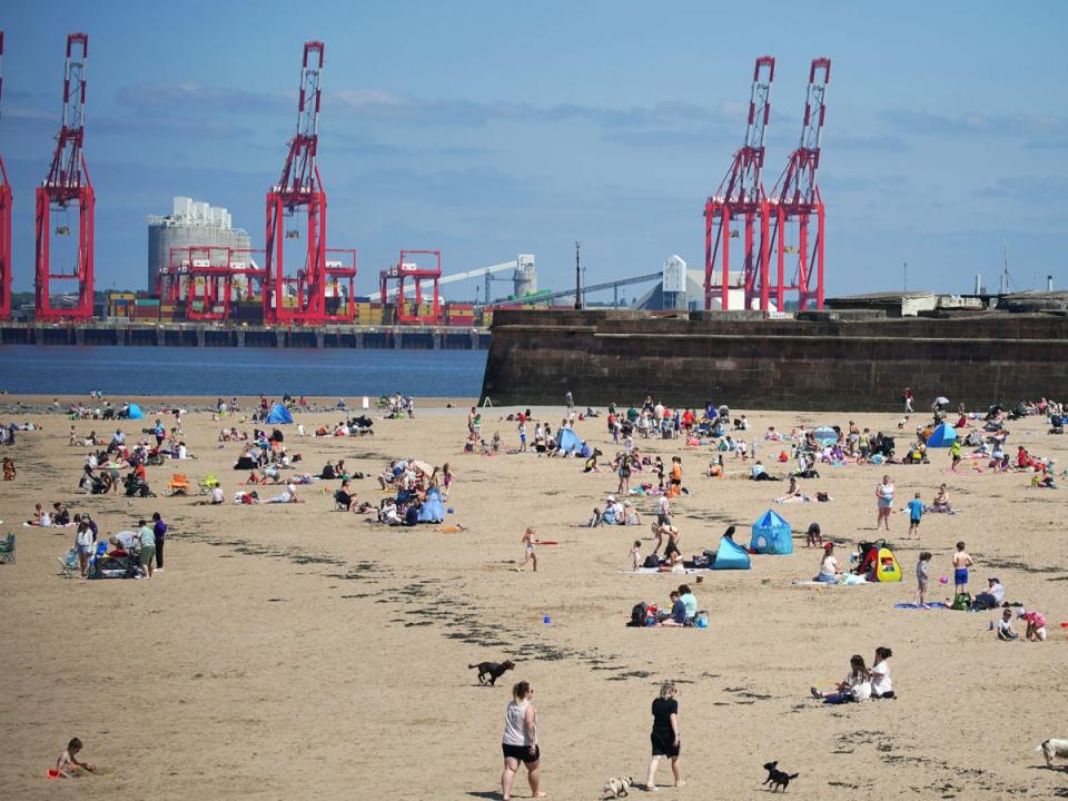 People on the beach at New Brighton on the Wirral, Merseyside (PA)