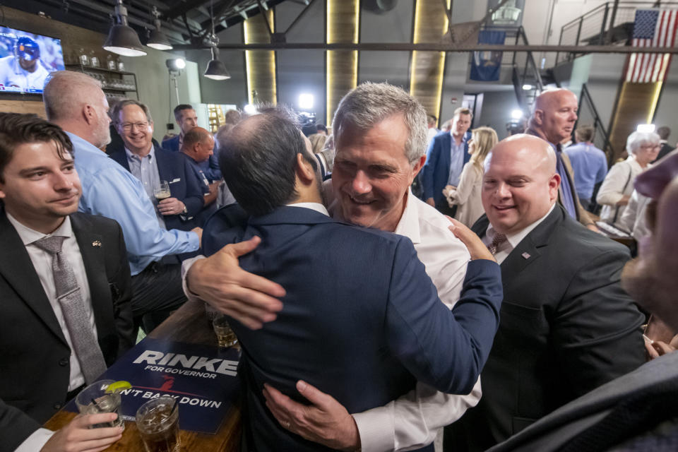 Michigan gubernatorial candidate Kevin Rinke hugs supporters during an election night party at The Dow at Dick O' Dow's, in Birmingham, Mich., Tuesday, Aug. 2, 2022. (David Guralnick/Detroit News via AP)