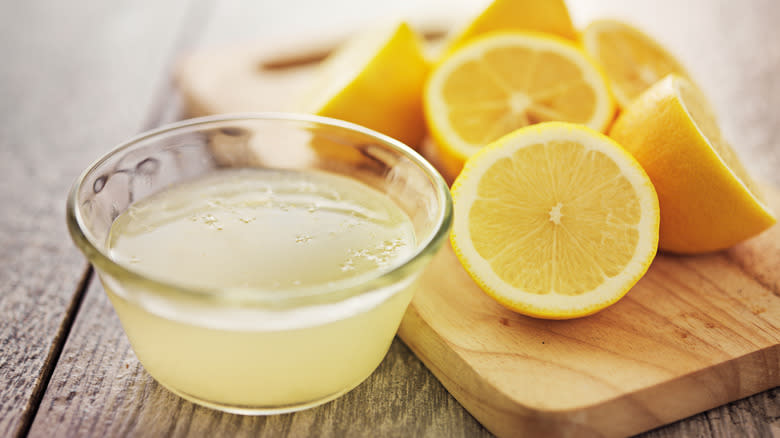 cut lemons and bowl of lemon juice