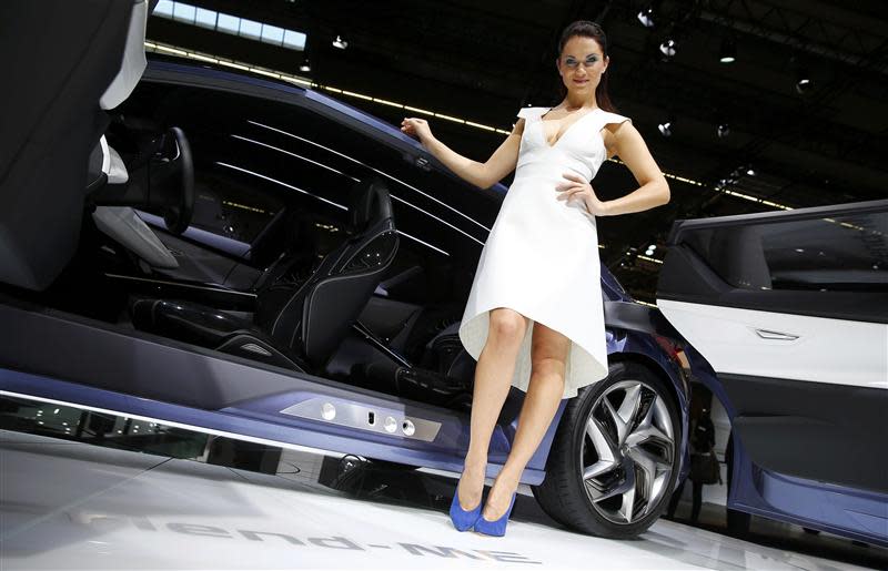 Model poses beside a Nissan 'Friend-Me' concept car at Frankfurt Motor Show