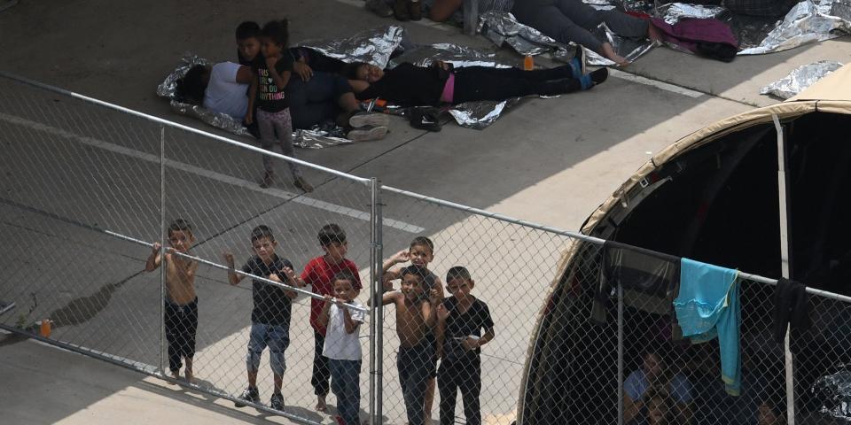 Migrants are seen outside the U.S. Border Patrol McAllen Station in a makeshift encampment in McAllen, Texas, U.S., May 15, 2019.