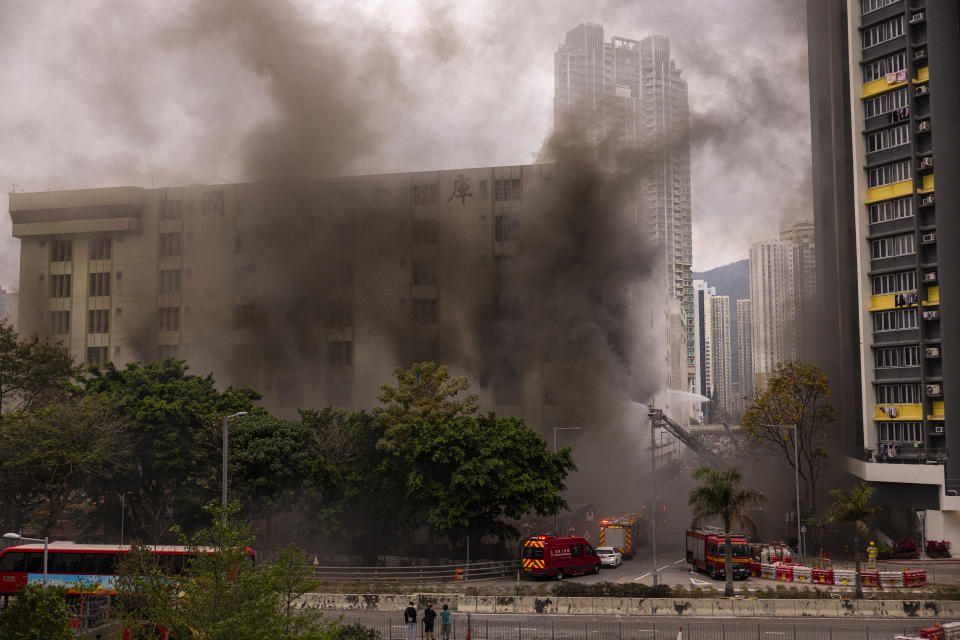 Firefighters battle a fire in Cheung Sha Wan, a residential and industrial area, in Hong Kong, Friday, March 24, 2023. (AP Photo/Louise Delmotte)