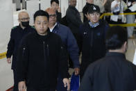 Los Angeles Dodgers pitcher Yoshinobu Yamamoto, right, walks through a terminal during the baseball team's arrival at Incheon International Airport, Friday, March 15, 2024, in Incheon, South Korea, ahead of the team's baseball series against the San Diego Padres. (AP Photo/Ahn Young-joon)