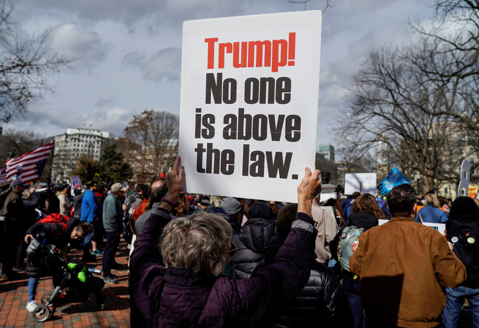 A woman holds a sign during a demonstration against U.S. President Donald Trump on President's Day near the White House in Washington, Feb. 18, 2019.  (Photo: Joshua Roberts/Reuters)