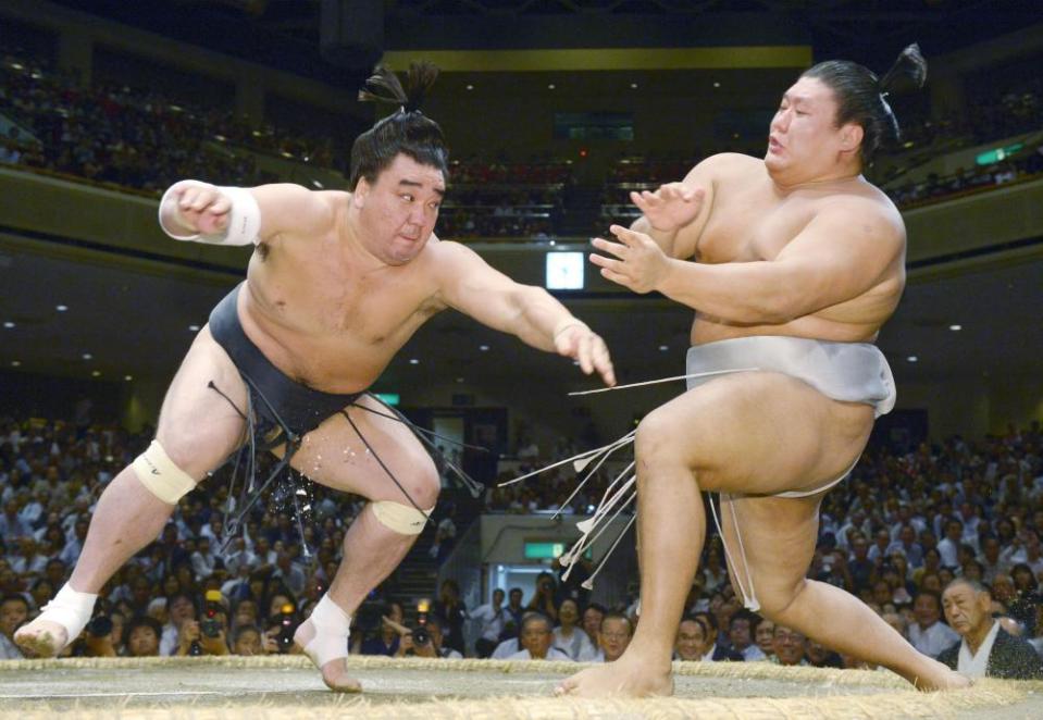 Harumafuji, left, fights Takanoiwa in the ring in September 2016.