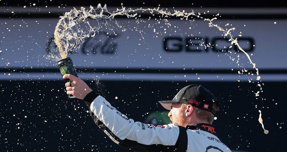 Tyler Reddick sprays Monster Energy in Victory Lane after winning at Talladega.