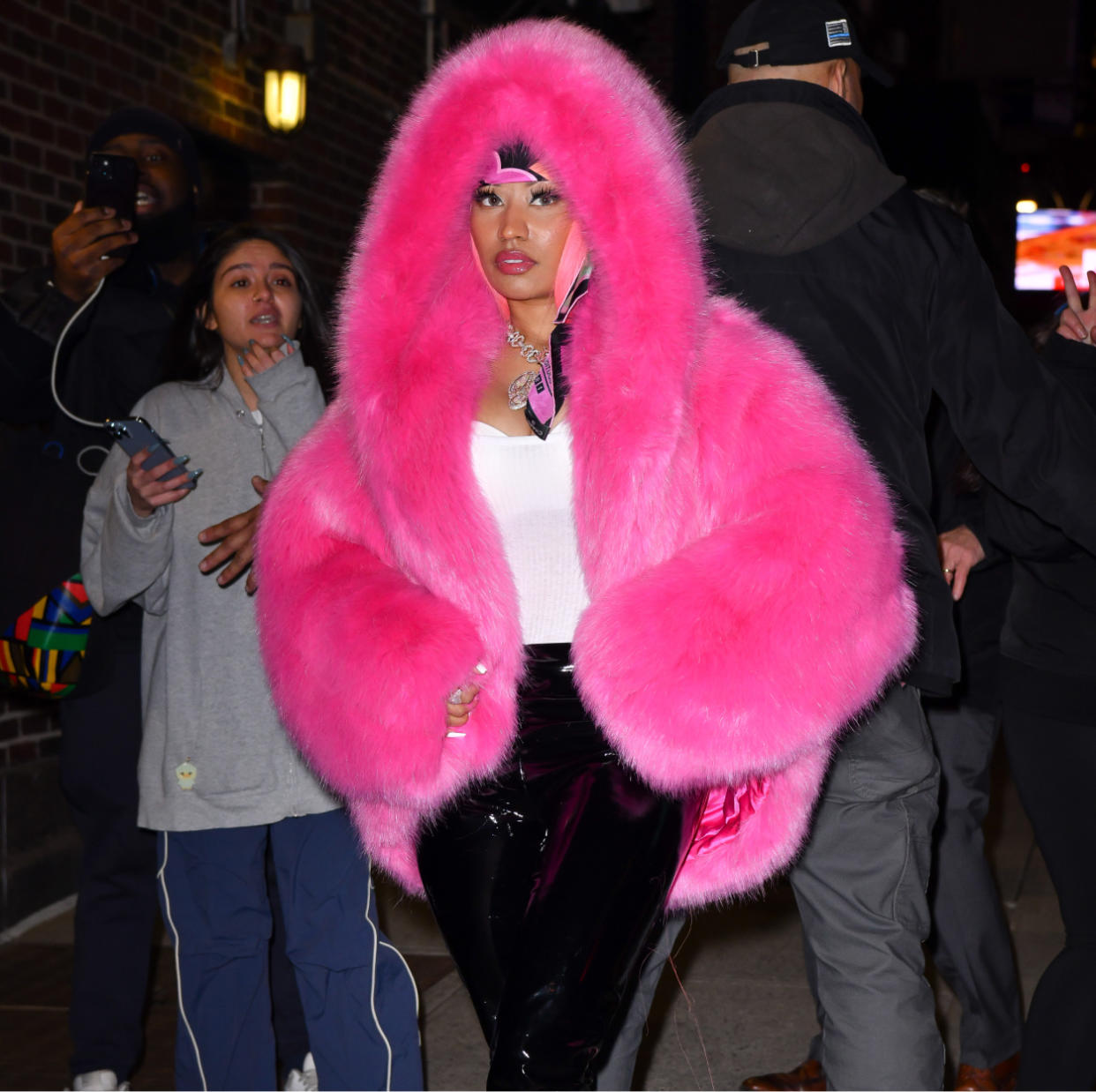  Nicki Minaj in a pink fur coat and yellow fur coat. 