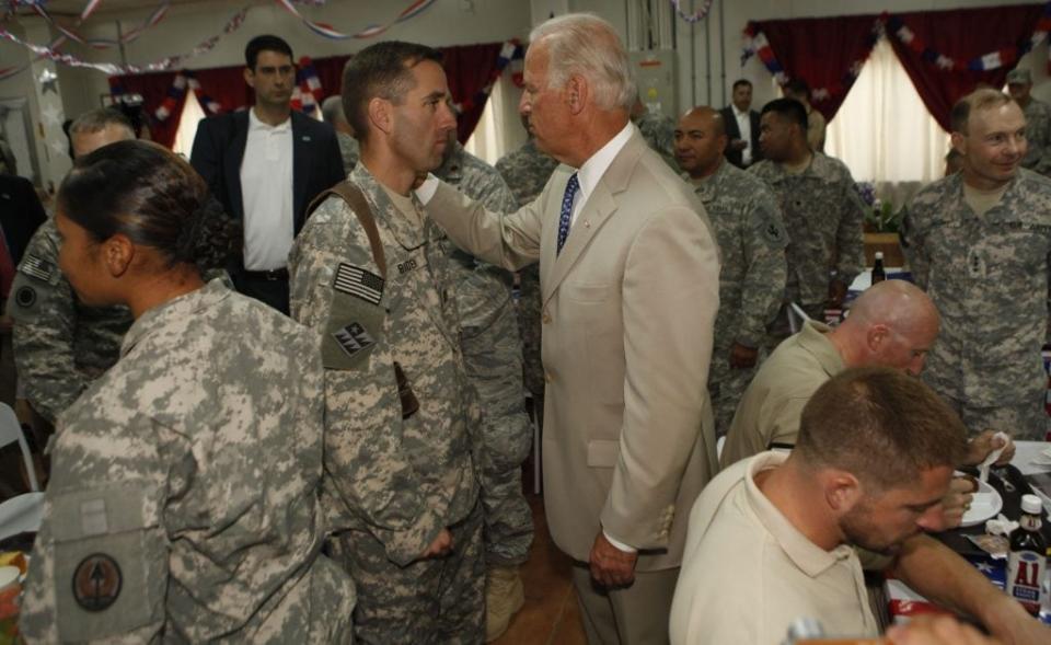 U.S. Vice President Joe Biden talks with his son U.S. Army Capt. Beau Biden (L) at Camp Victory on July 4, 2009 near Baghdad, Iraq. Bidden’s first visit to Iraq as the Vice President comes days after U.S. forces pulled out from Iraq’s cities. (Photo by Khalid Mohammed-Pool/Getty Images)