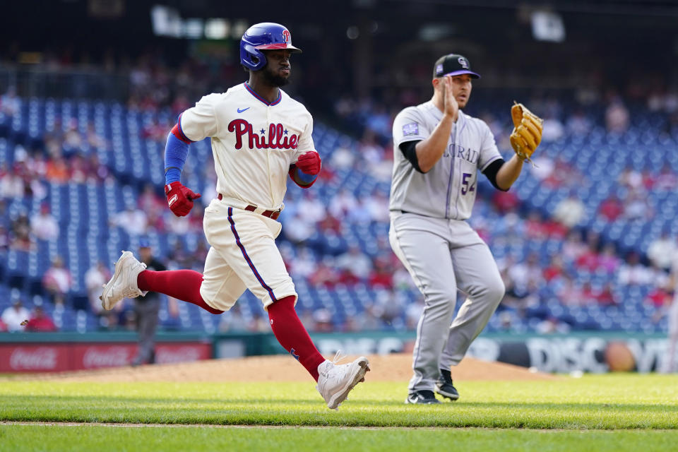 Philadelphia Phillies' Odubel Herrera, left, and Colorado Rockies' Carlos Estevez react as Herrera grounds out to end a baseball game, Sunday, Sept. 12, 2021, in Philadelphia. (AP Photo/Matt Slocum)