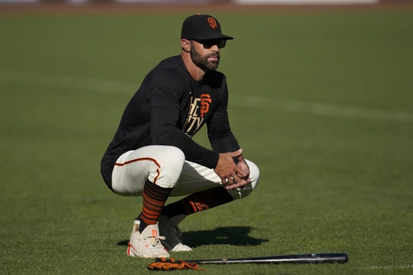 San Francisco Giants manager Gabe Kapler watches players during a baseball practice.