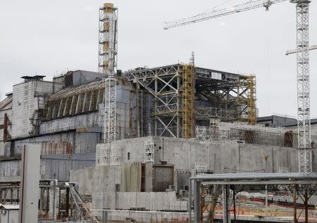 A sarcophagus covering the damaged fourth reactor is seen at the Chernobyl nuclear power plant, Ukraine, March 23, 2016. Picture taken through a window. REUTERS/Gleb Garanich