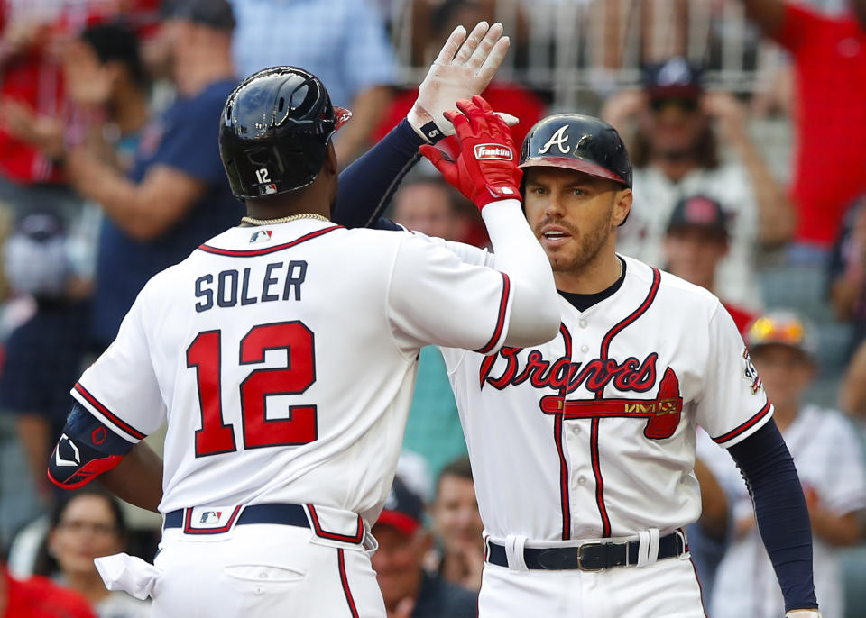 ATLANTA, GA - AUGUST 07: Jorge Soler #12 of the Atlanta Braves reacts with Freddie Freeman #5 after hitting a solo home run in the first inning of an MLB game against the Washington Nationals at Truist Park on August 7, 2021 in Atlanta, Georgia. (Photo by Todd Kirkland/Getty Images)