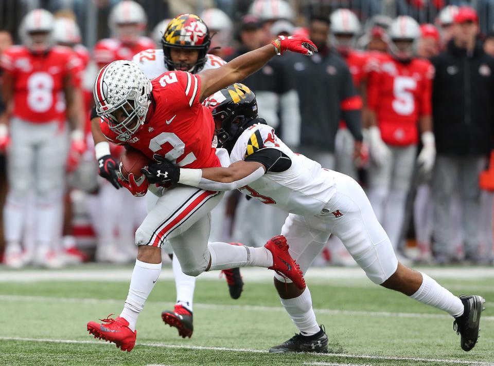 Ohio State running back J.K. Dobbins  tackled by Maryland defensive back Nick Cross during the first quarter at Ohio Stadium.