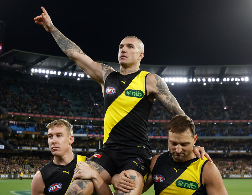 MELBOURNE, AUSTRALIA - JUNE 15: Dustin Martin of the Tigers is chaired from the field after his 300th match by teammates Tom Lynch (left) and Toby Nankervis (right0 during the 2024 AFL Round 14 match between the Richmond Tigers and the Hawthorn Hawks at The Melbourne Cricket Ground on June 15, 2024 in Melbourne, Australia. (Photo by Michael Willson/AFL Photos via Getty Images)