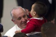 Pope Francis has his skull cap removed by a child during an audience with children assisted by volunteers of Santa Marta institute in Paul VI hall at the Vatican December 14, 2013. REUTERS/Giampiero Sposito (VATICAN - Tags: RELIGION SOCIETY)