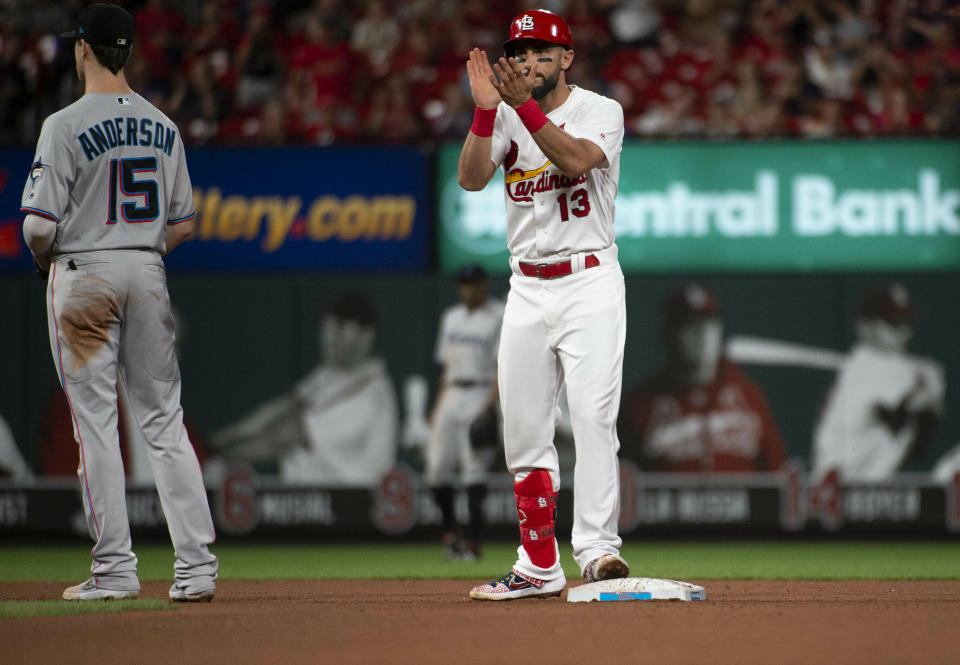 St. Louis Cardinals' Matt Carpenter, right, celebrates a bunt double as he stands on second base in front of Miami Marlins third baseman Brian Anderson, left, during the fifth inning of a baseball game Monday, June 17, 2019, in St. Louis. (AP Photo/L.G. Patterson)
