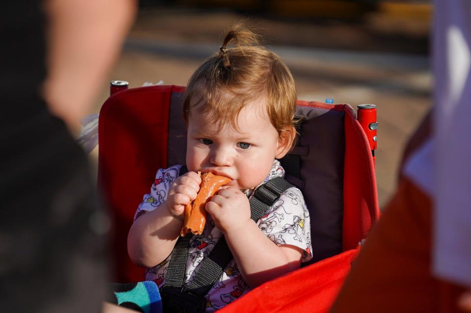 Xander Grandstaff eats a hot dog during SummerFest near the Kirkendall Public Library in Ankeny in 2022.