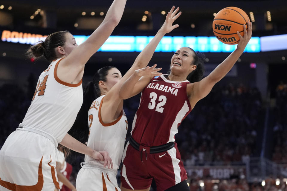 Alabama guard Aaliyah Nye (32) tries to shoot past Texas guard Shaylee Gonzales (2) and forward Taylor Jones (44) during the second half of a second-round college basketball game in the women’s NCAA Tournament in Austin, Texas, Sunday, March 24, 2024. (AP Photo/Eric Gay)