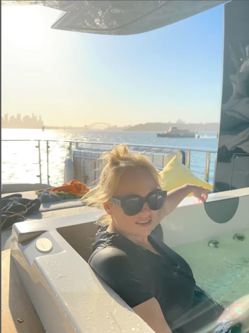 Rebel Wilson lounging in a hot tub on a yacht on Sydney Harbour