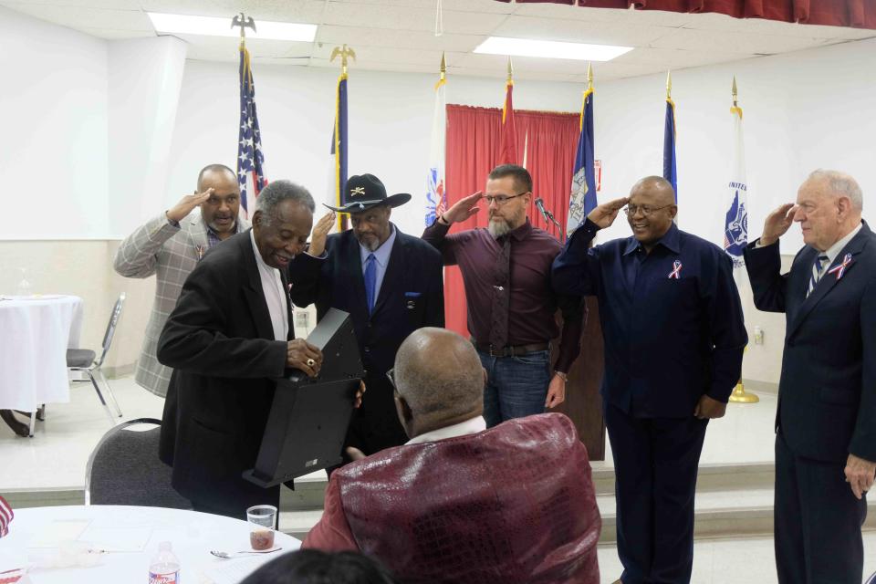 World War II-era U.S. Army veteran Edward Owens is saluted for his service Saturday during the Veteran's Honor Banquet at the United Citizen's Forum in Amarillo.