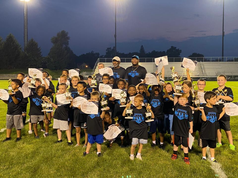 Brandon Hayes (middle), former NFL lineman, Muncie Southside High School graduate and founder of 3rd & 11 Inc., has organized four football combines for local youth that encourage exercise and sports participation.