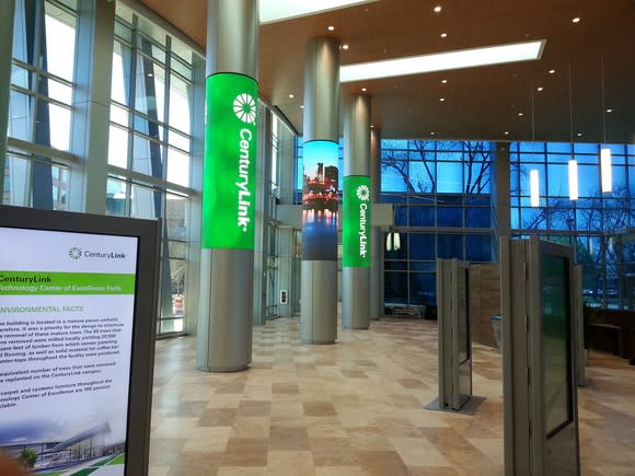 Lobby with vaulted ceilings and CenturyLink logos on the columns.