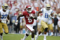 Oklahoma wide receiver Marquise Brown (5) runs away from UCLA defensive back Quentin Lake (37) and linebacker Keisean Lucier-South (11) for a touchdown in the first quarter of an NCAA college football game in Norman, Okla., Saturday, Sept. 8, 2018. (AP Photo/Sue Ogrocki)
