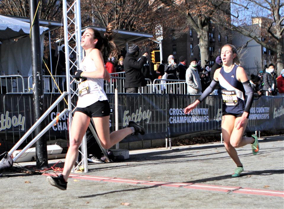 Ursuline's Daphne Banino sprints across the finish of the girls Eastbay Cross-Country Northeast Regional qualifier for Foot Locker Nationals in front of Pennsylvania's Mia Cochran on Saturday in Van Cortlandt Park in the Bronx. Banino, who was eighth, and Cochran, ninth, both qualified for the December 11 Foot Locker Cross-Country Nationals in San Diego, California.