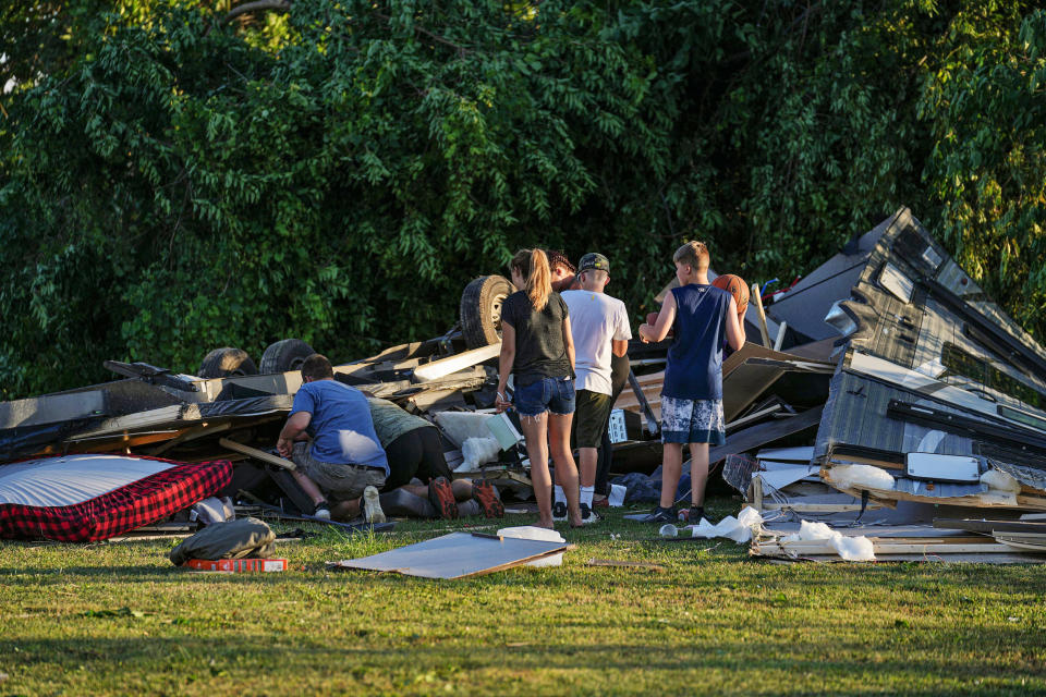 People survey what's left of an RV camper after a tornado touched down in several areas of Greenwood, Ind., on Sunday afternoon, June 25, 2023.  (Jenna Watson / IndyStar / USA Today Network)