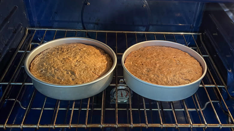 Vegan carrot cake in round cake pans in oven