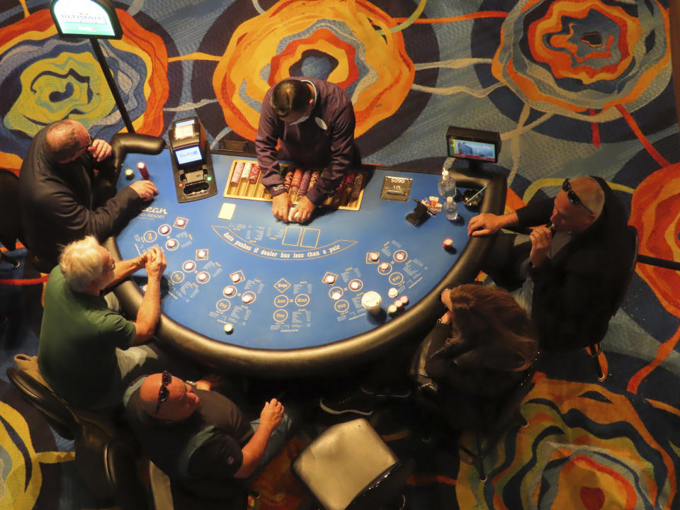 A card dealer at the Ocean Casino Resort in Atlantic City, N.J., conducts a game on Dec. 2, 2022. New development projects at casinos and a former airport site, along with a long-awaited year-round water park are among things expected to happen in Atlantic City in 2023. (AP Photo/Wayne Parry)