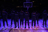 The Memphis Grizzlies stand for a moment of silence before an NBA basketball game between the Minnesota Timberwolves and the Memphis Grizzlies, Friday, Jan. 27, 2023, in Minneapolis. Nichols was on his way home from taking pictures of the sky on Jan. 7, when police pulled him over. He was just a few minutes from home when he was killed in what authorities have described as a brutal attack by five Memphis police officers, who have since been charged with second-degree murder and other offenses.