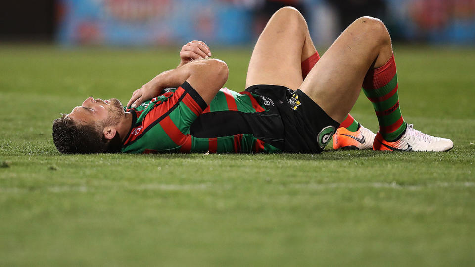 Burgess clutches at his troublesome shoulder during a game against Canberra.