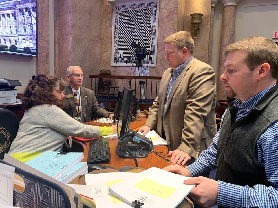 Rep. Jason Petrie, R-Elkton, (second from right) files his state budget bill Friday.